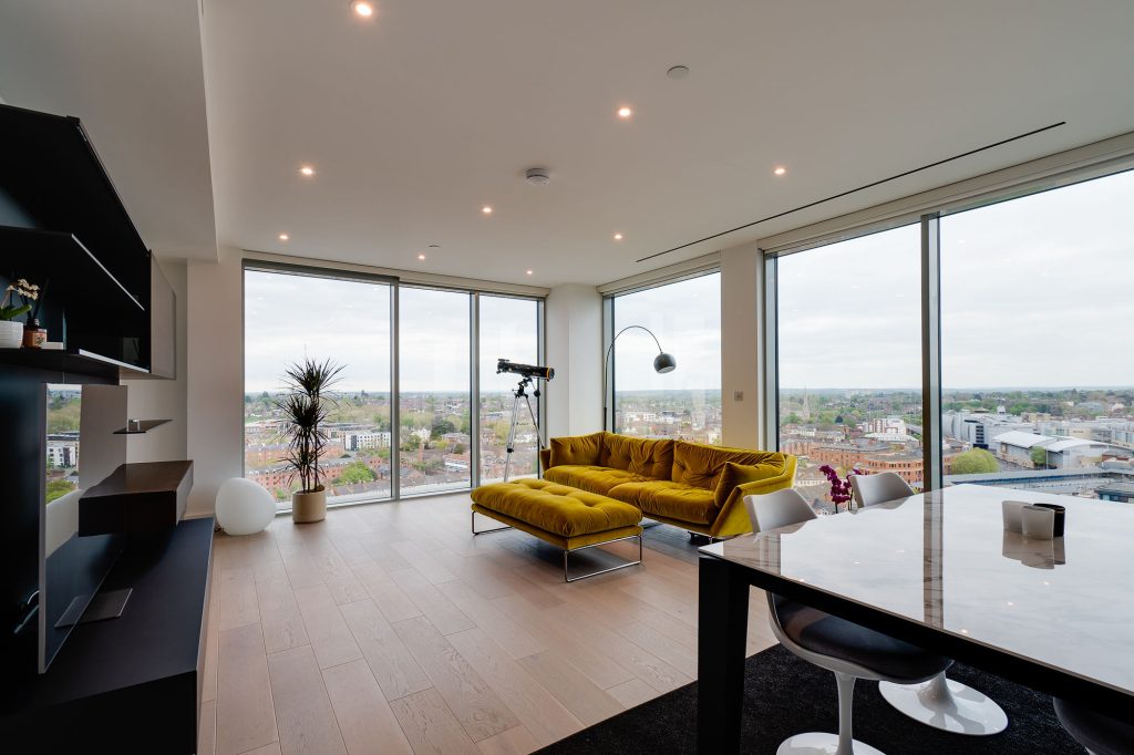 a view of a living room filled with furniture and a large window
