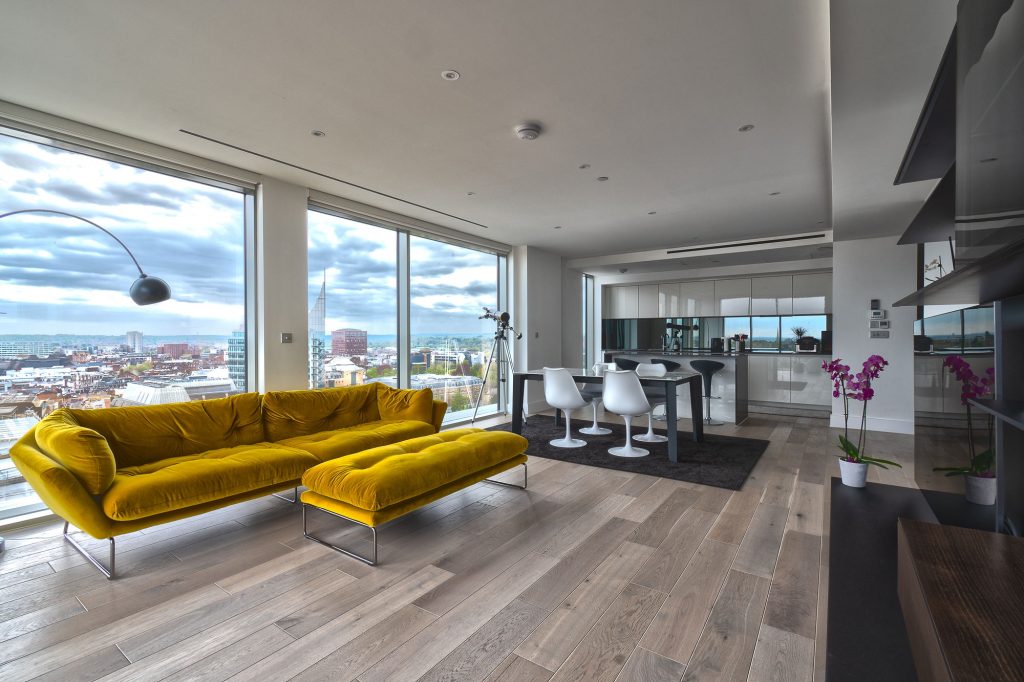 a living room filled with furniture and a large window