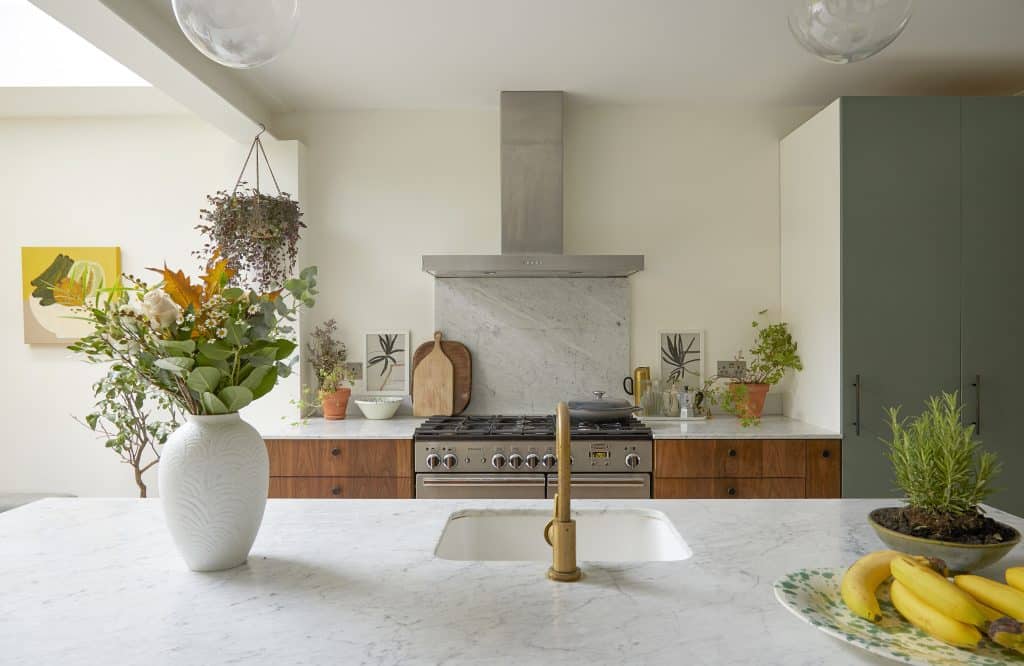 a living room filled with furniture and vase of flowers on a table