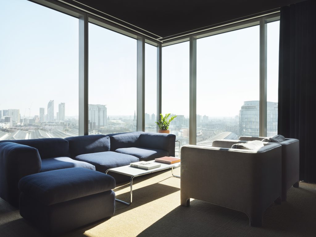 a view of a living room filled with furniture and a large window
