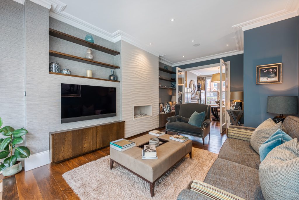 a living room filled with furniture and a fire place