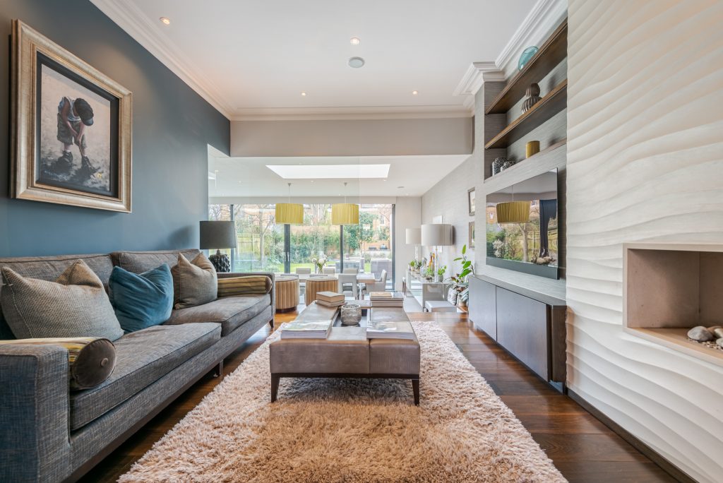 a living room filled with furniture and a large window