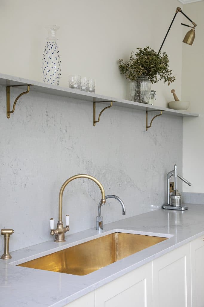 a kitchen with a sink and a mirror