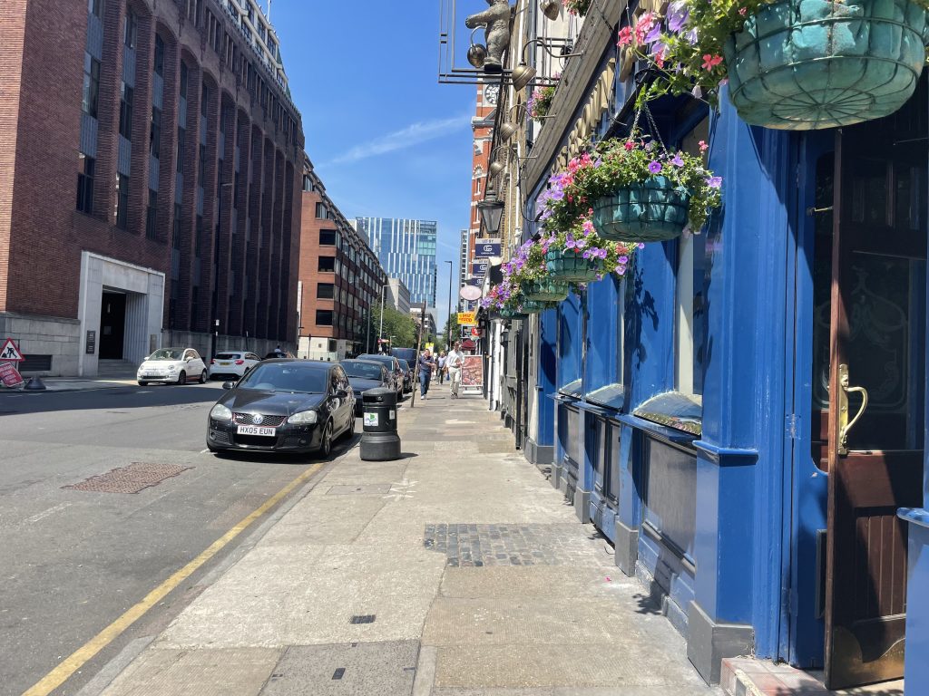 a group of people walking on a city street