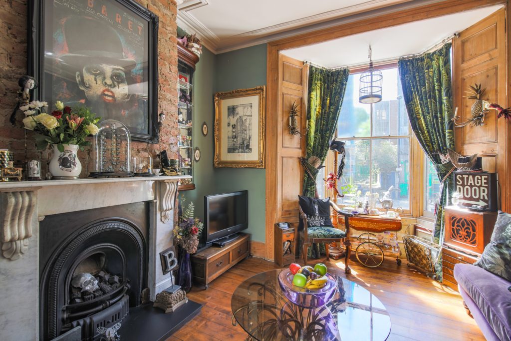 a living room filled with furniture and a fire place