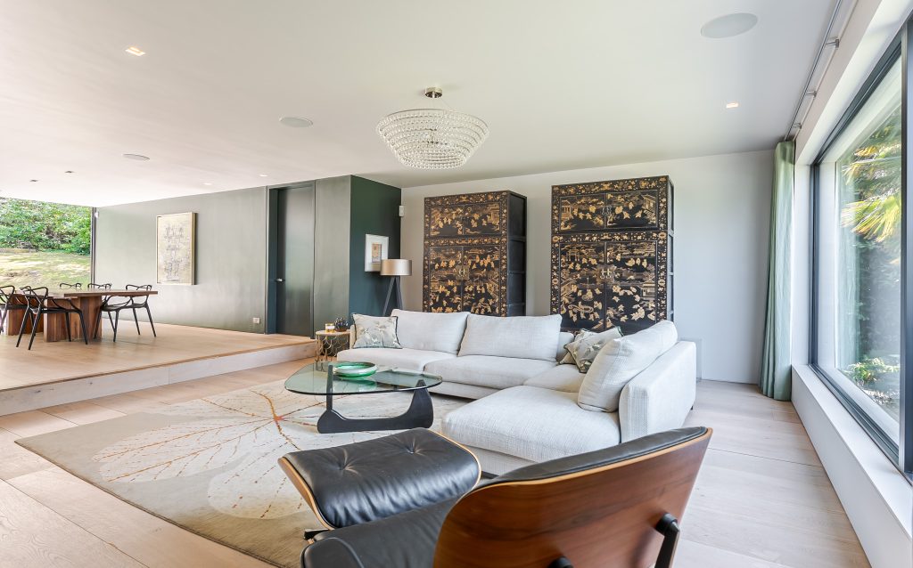 a living room filled with furniture and a large window