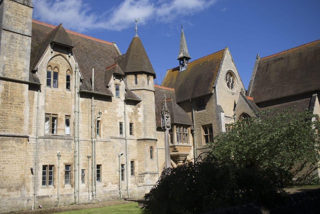 a large stone building with Château de Fougères-sur-Bièvre in the background
