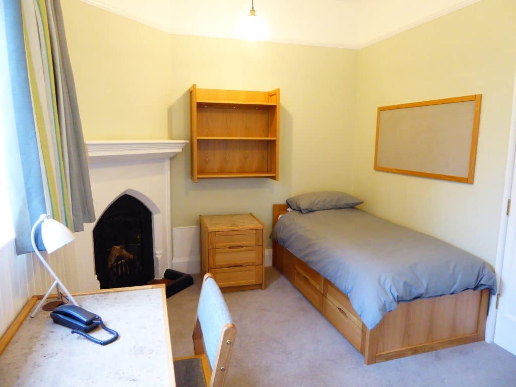 a bedroom with a bed in a room