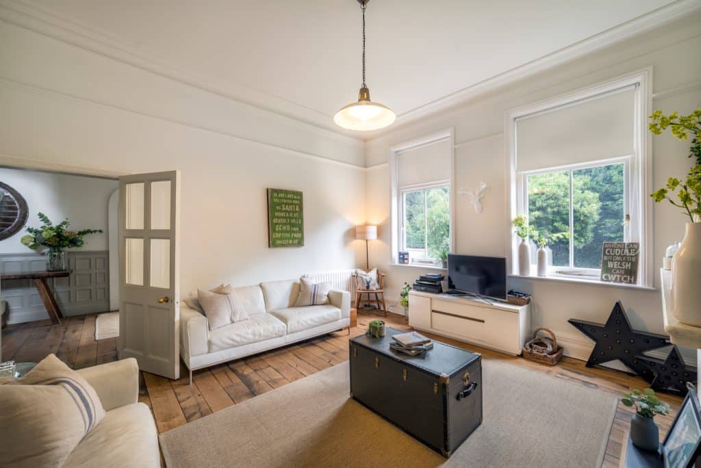 a living room filled with furniture and a flat screen tv