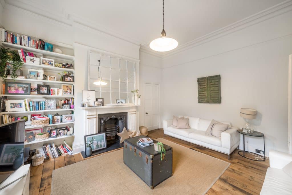 a living room filled with furniture and a book shelf