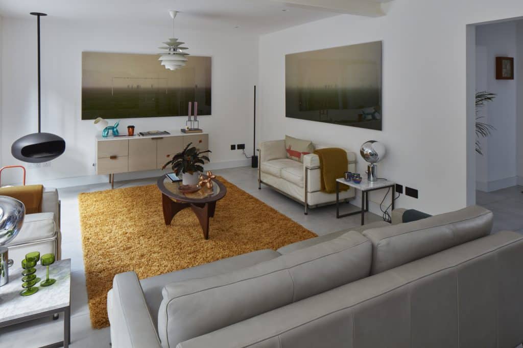 a living room filled with furniture and a flat screen tv
