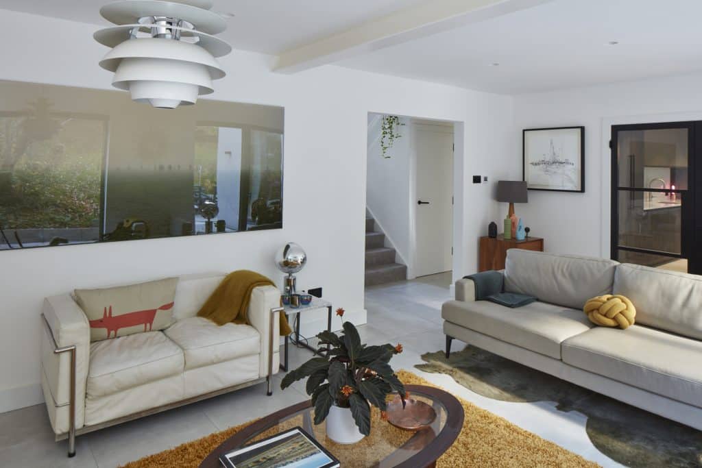 a living room filled with furniture and a large mirror