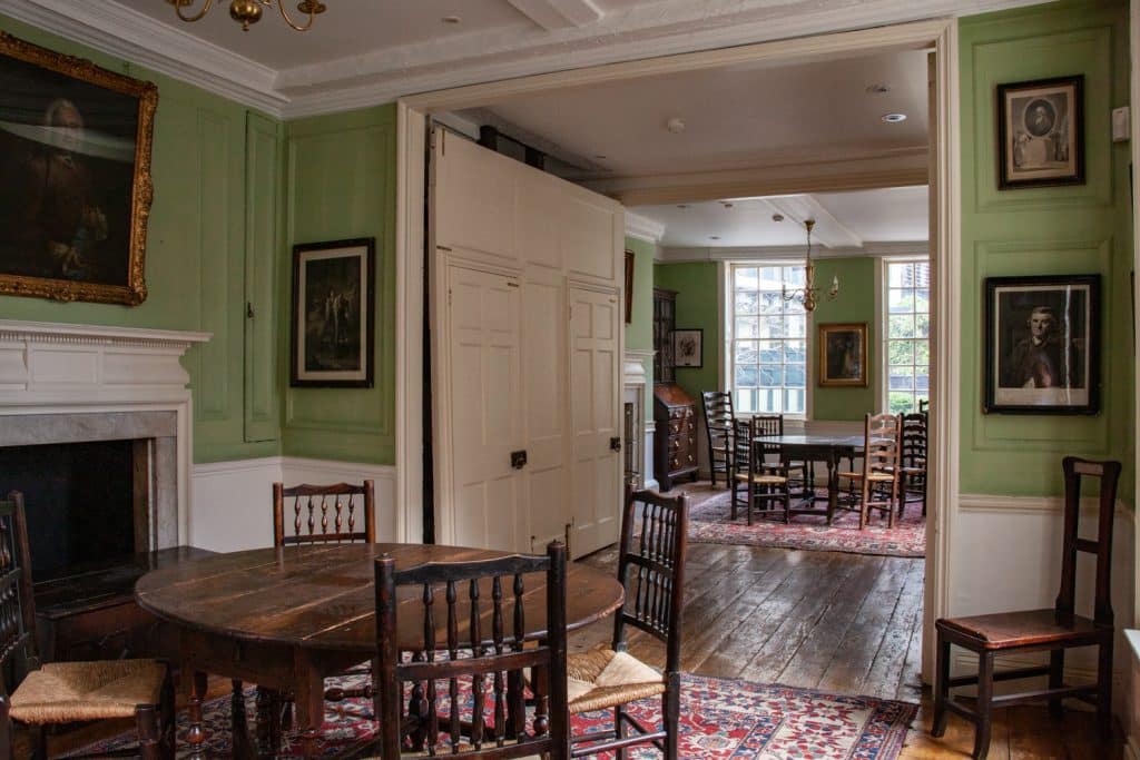 a living room filled with furniture and a fire place and a dining table