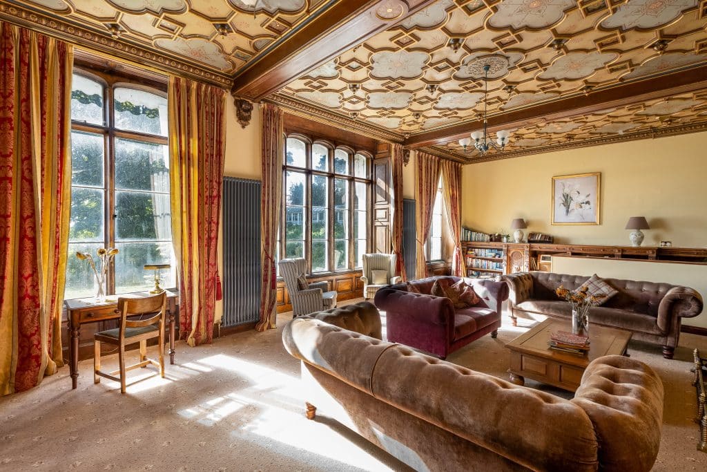 a living room filled with furniture and a large window
