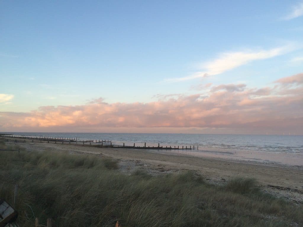 a group of clouds in the sky on a beach