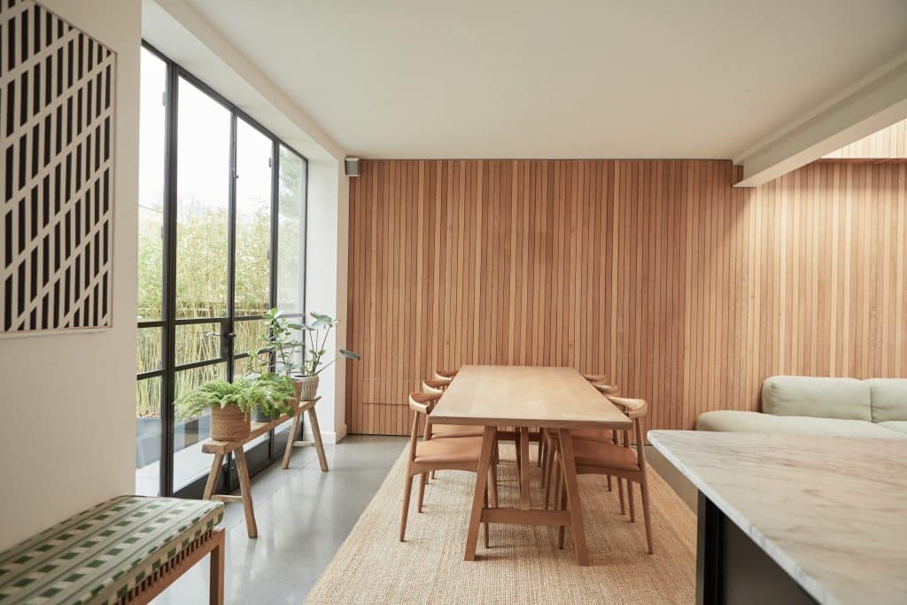 a bedroom with a bed and a chair in a room