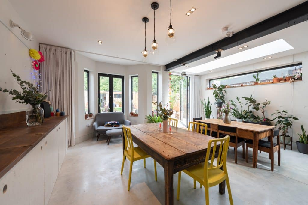 a living room filled with furniture and a large window