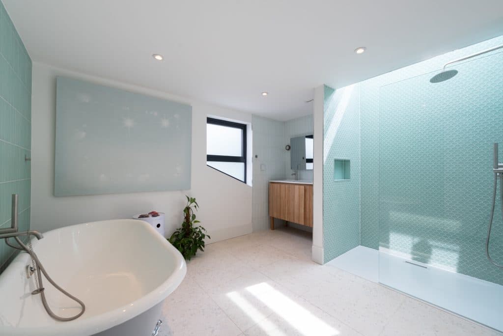 a room with a large tub next to a sink