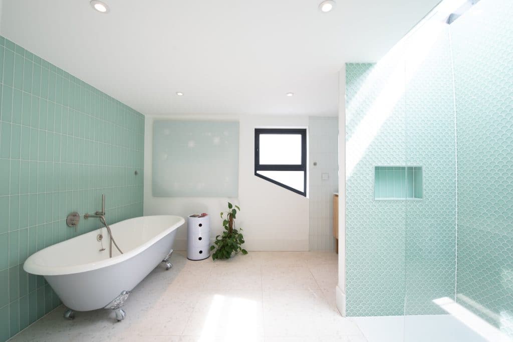 a room with a green tub and sink