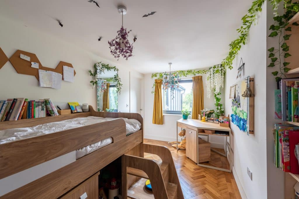 a bedroom with a bed and desk in a room