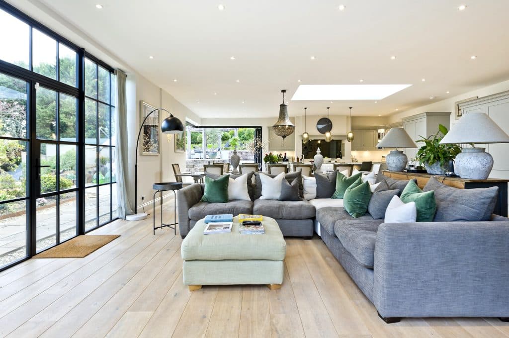a living room filled with furniture and a large window