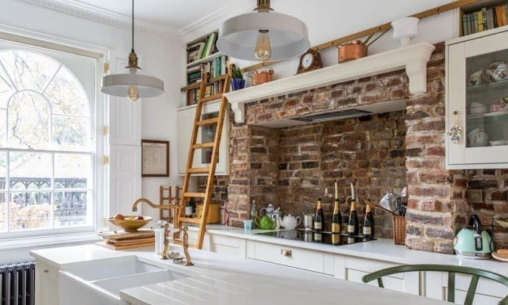 a kitchen with a fireplace and a large window