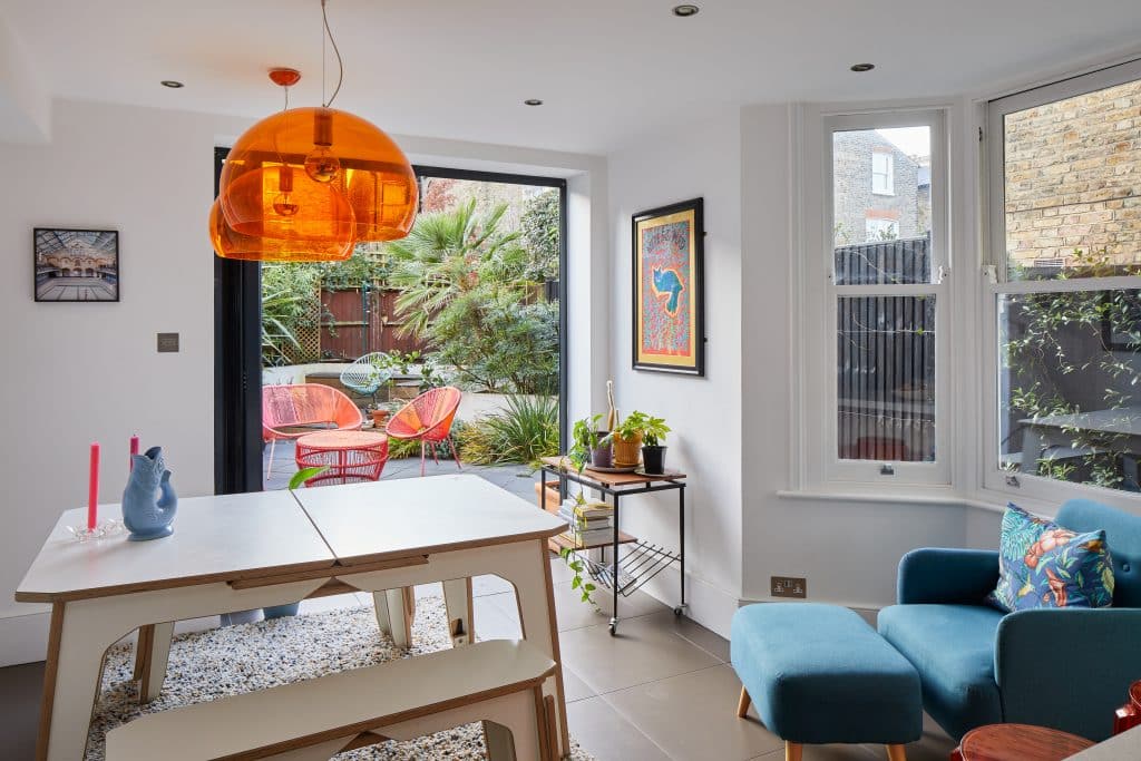 a living room filled with furniture and a large window