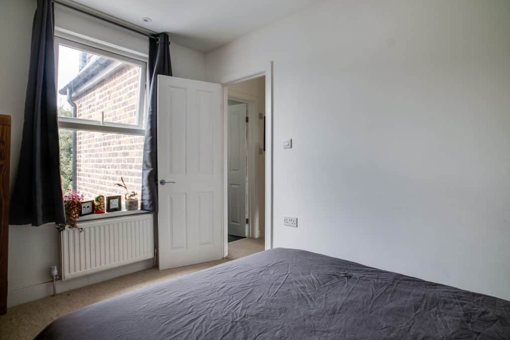 a bedroom with a large window