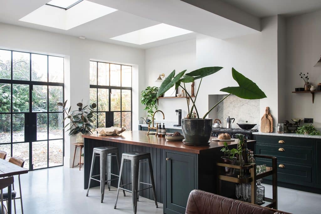 a living room filled with furniture and vase of flowers on a table