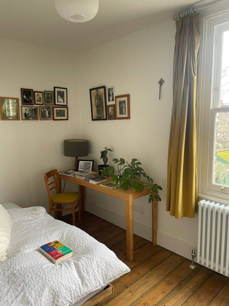 a bedroom with a bed and desk in a room