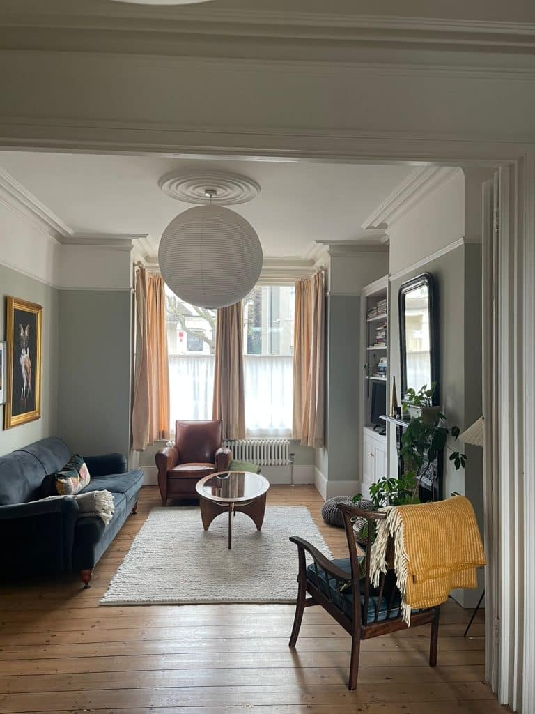 a living room filled with furniture and a large window