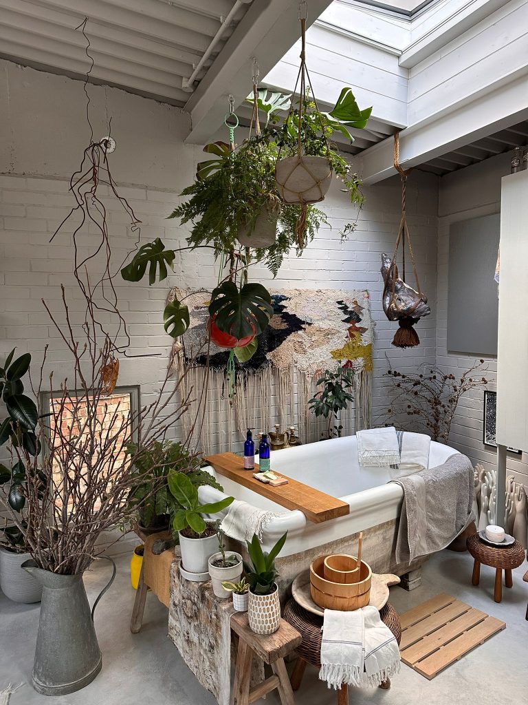 a room filled with furniture and vase of flowers on a table