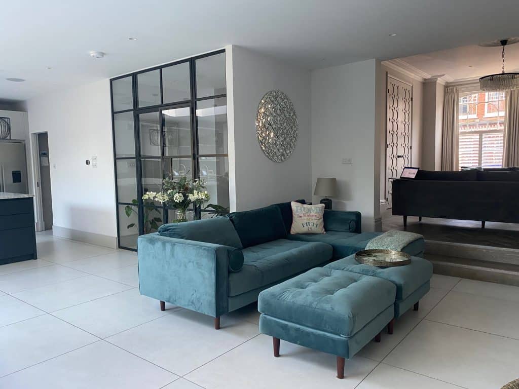 a living room filled with furniture and a large window