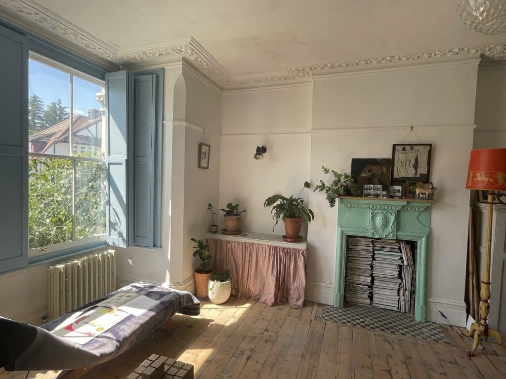 a living room filled with furniture and a large window