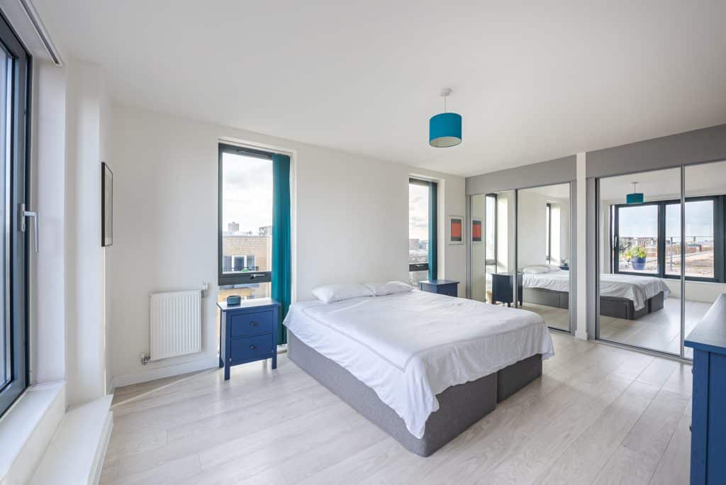 a bedroom with a large bed in a room