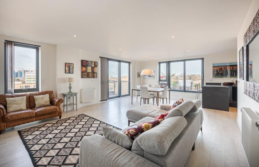 a living room filled with furniture and a large window