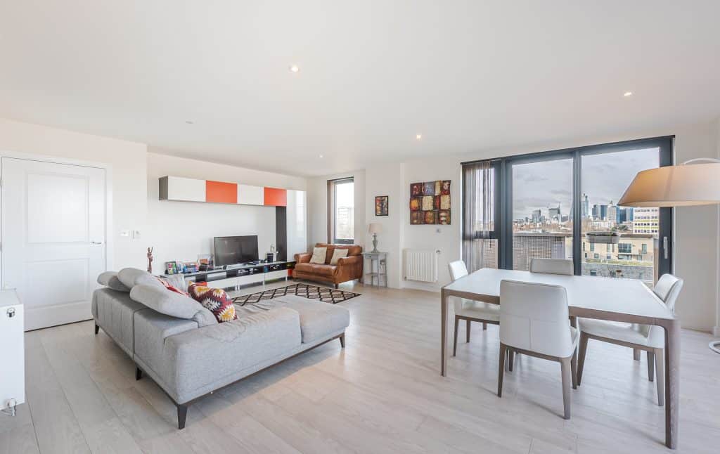 a living room filled with furniture and a large window