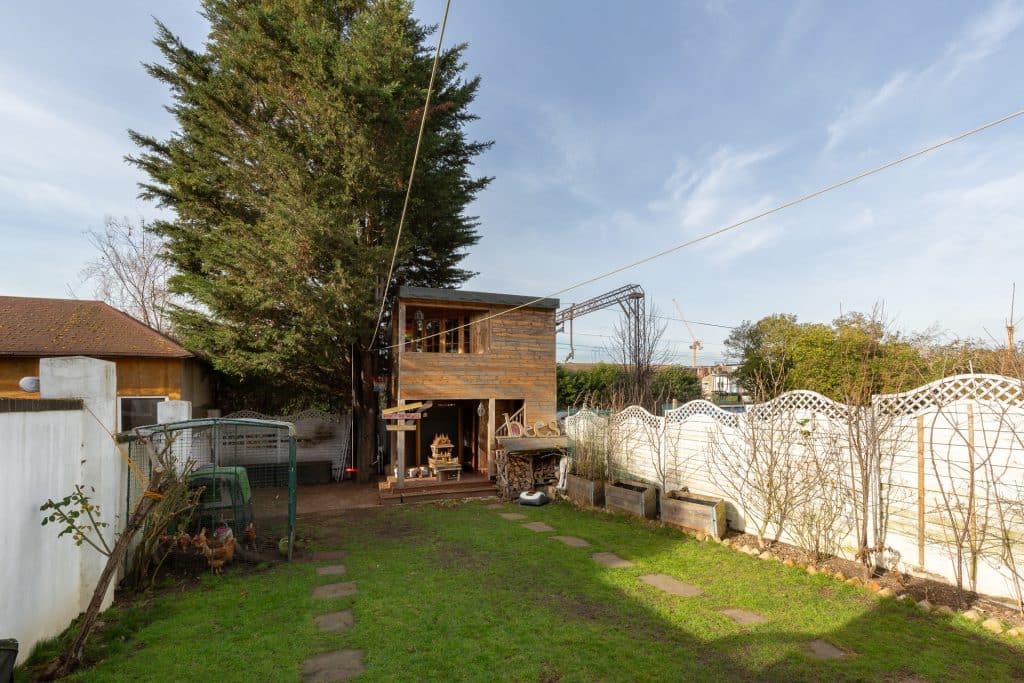 a house with a fence in front of a building