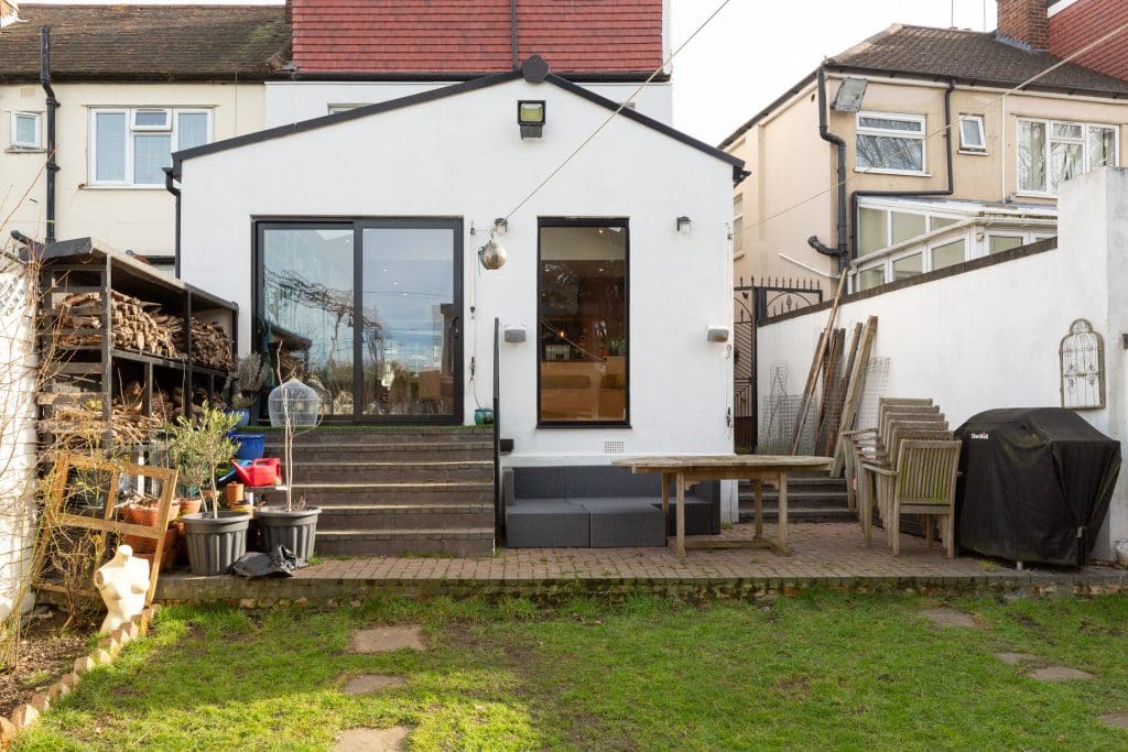 a cow is standing in front of a house