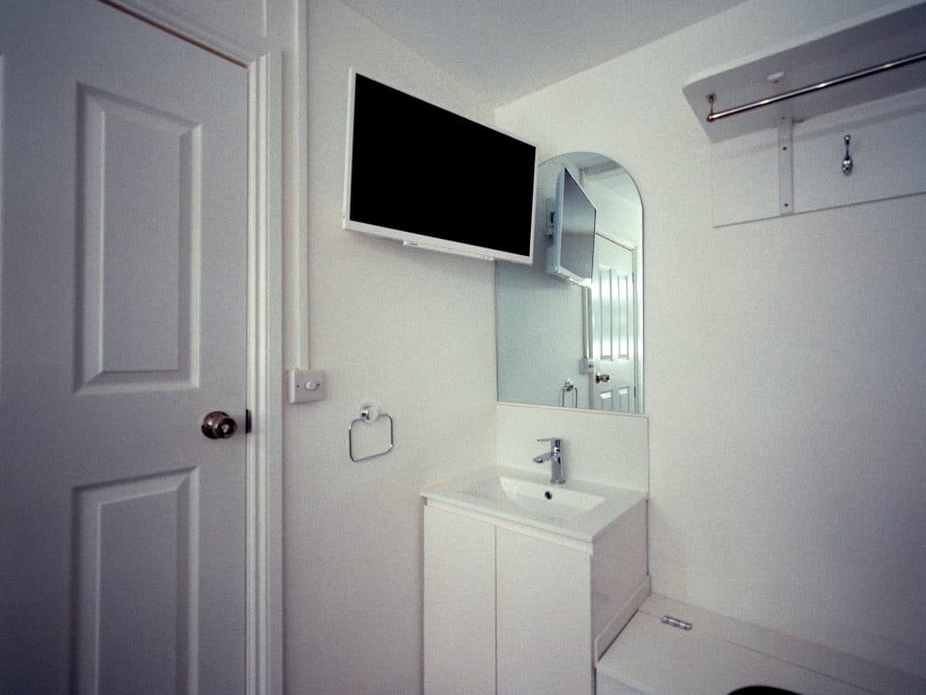a room with a sink and a mirror