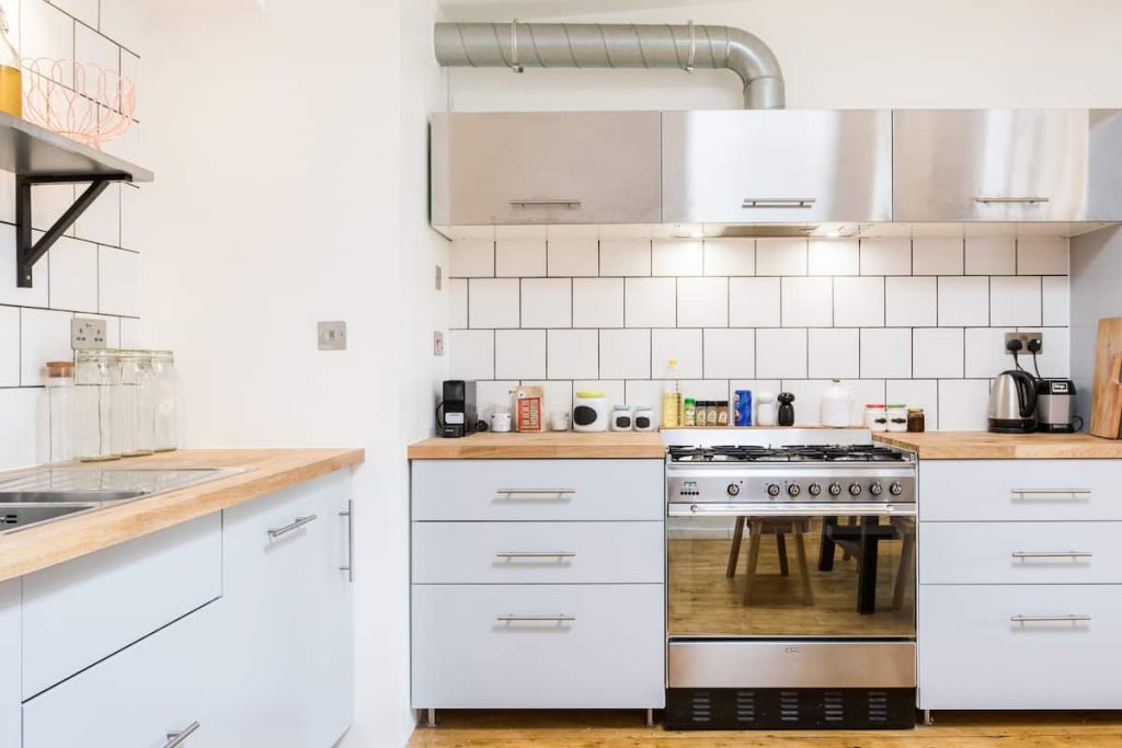 a stove top oven sitting inside of a kitchen