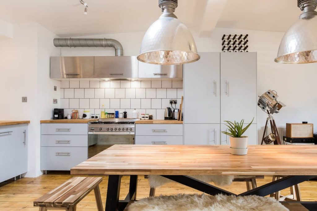 a kitchen with wooden cabinets and a dining room table
