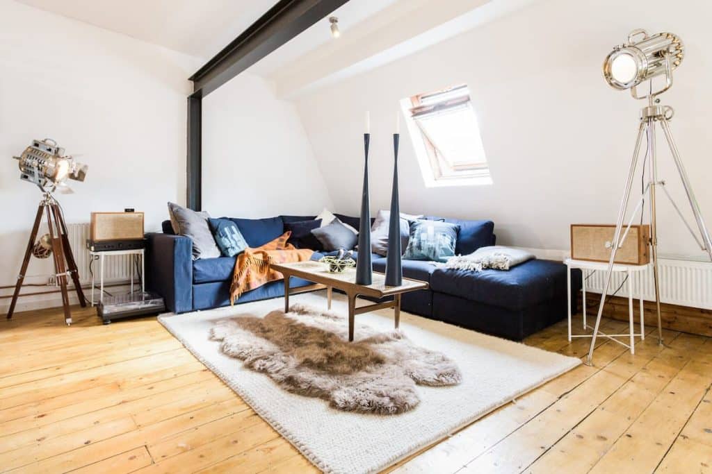 a bedroom with a bed and a chair in a room