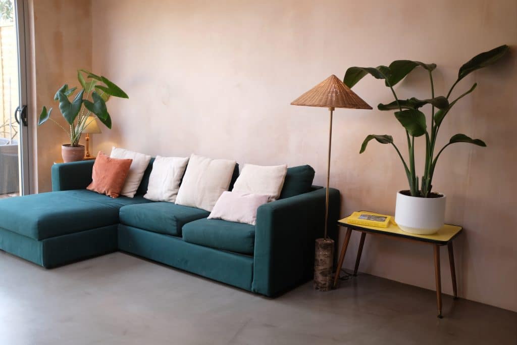 a living room filled with furniture and a lamp