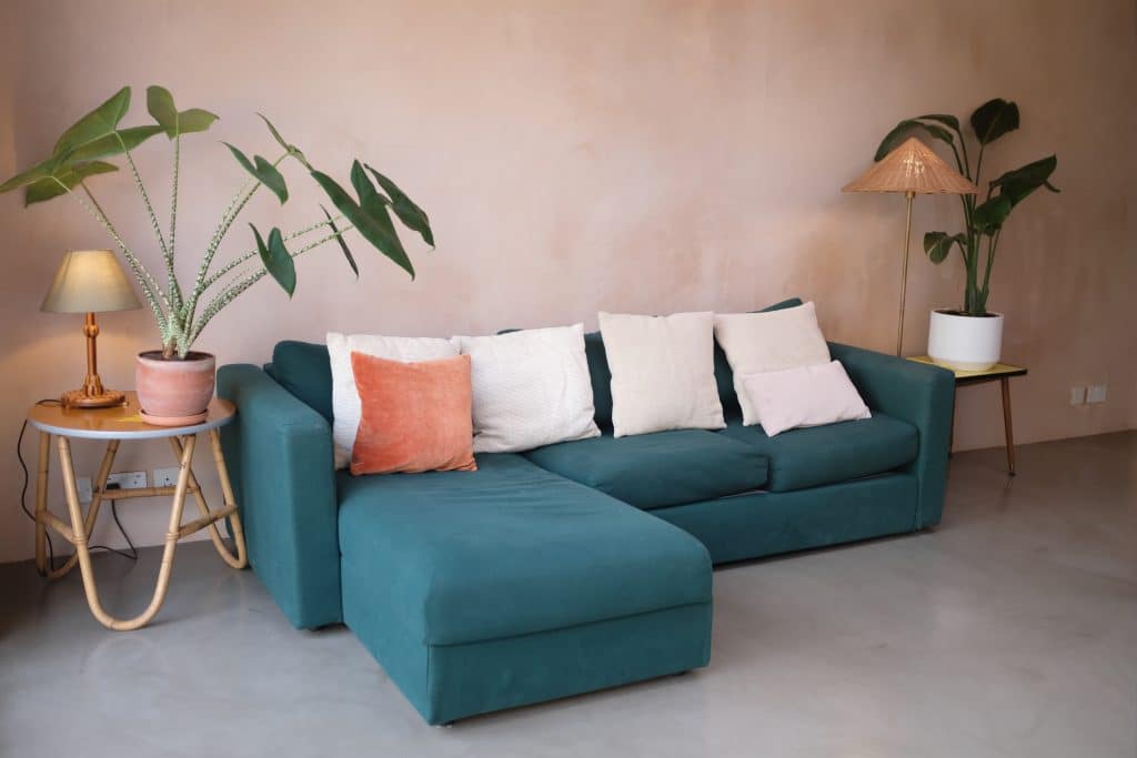 a living room filled with furniture and a lamp