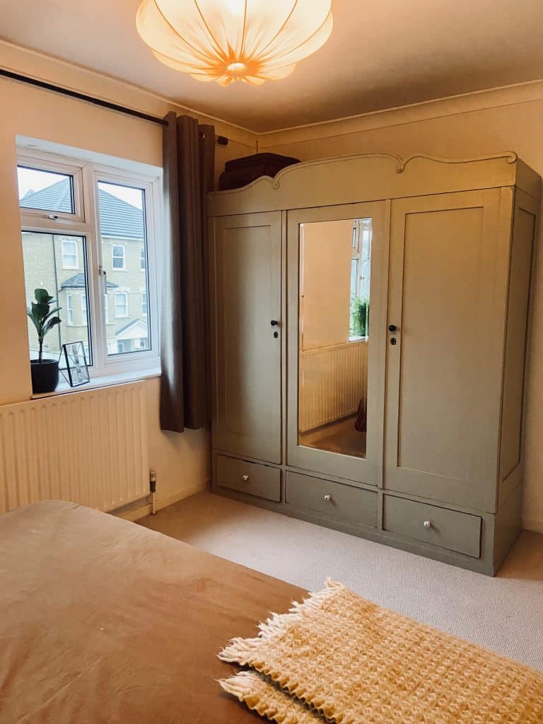 a bedroom with a bed and a mirror