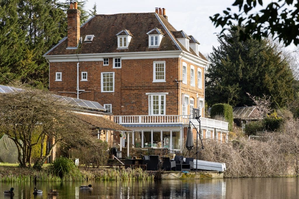 a small house surrounded by water