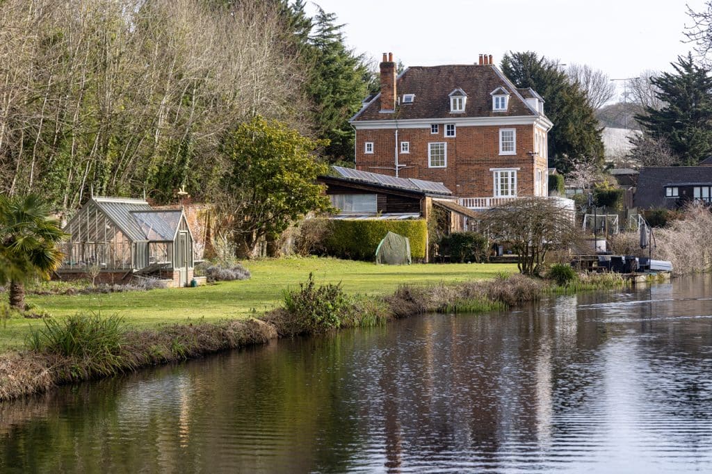 a small house surrounded by water