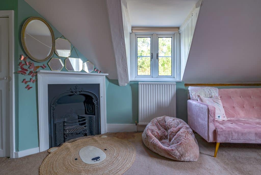 a bedroom with a fireplace and a large window