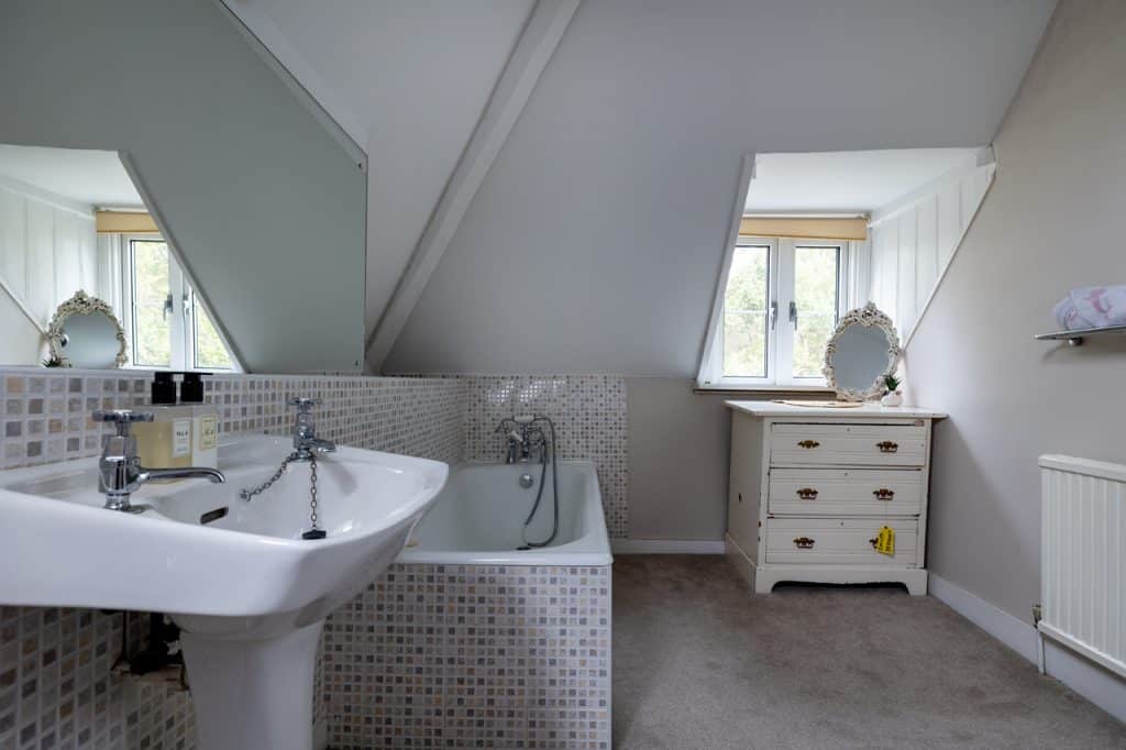 a room with a sink and a mirror